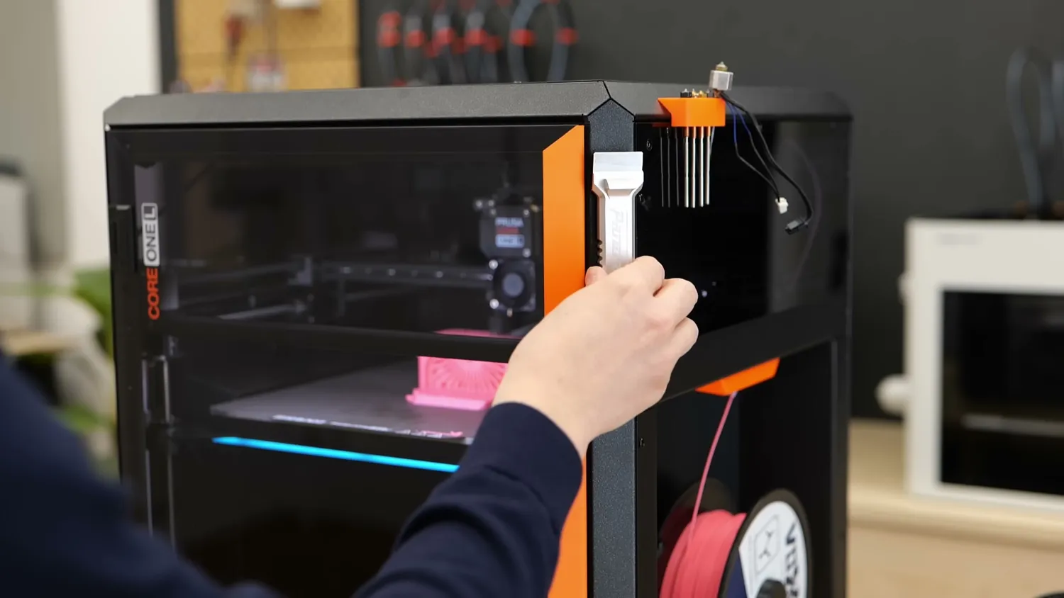 A magnetic tool holder stuck to the side panel of the CORE One L