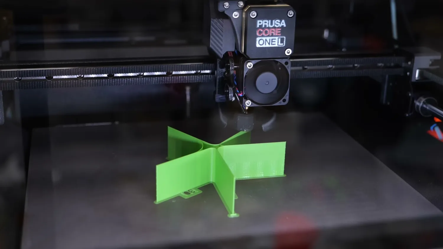 The green VFA test part being printed on the CORE One L