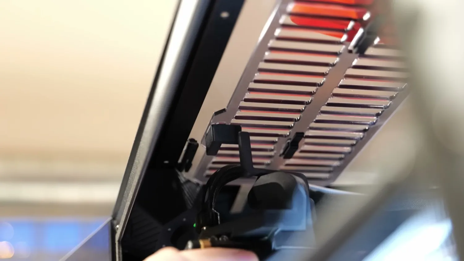 The underside of the top vent, its louvers driven by a flexible lever