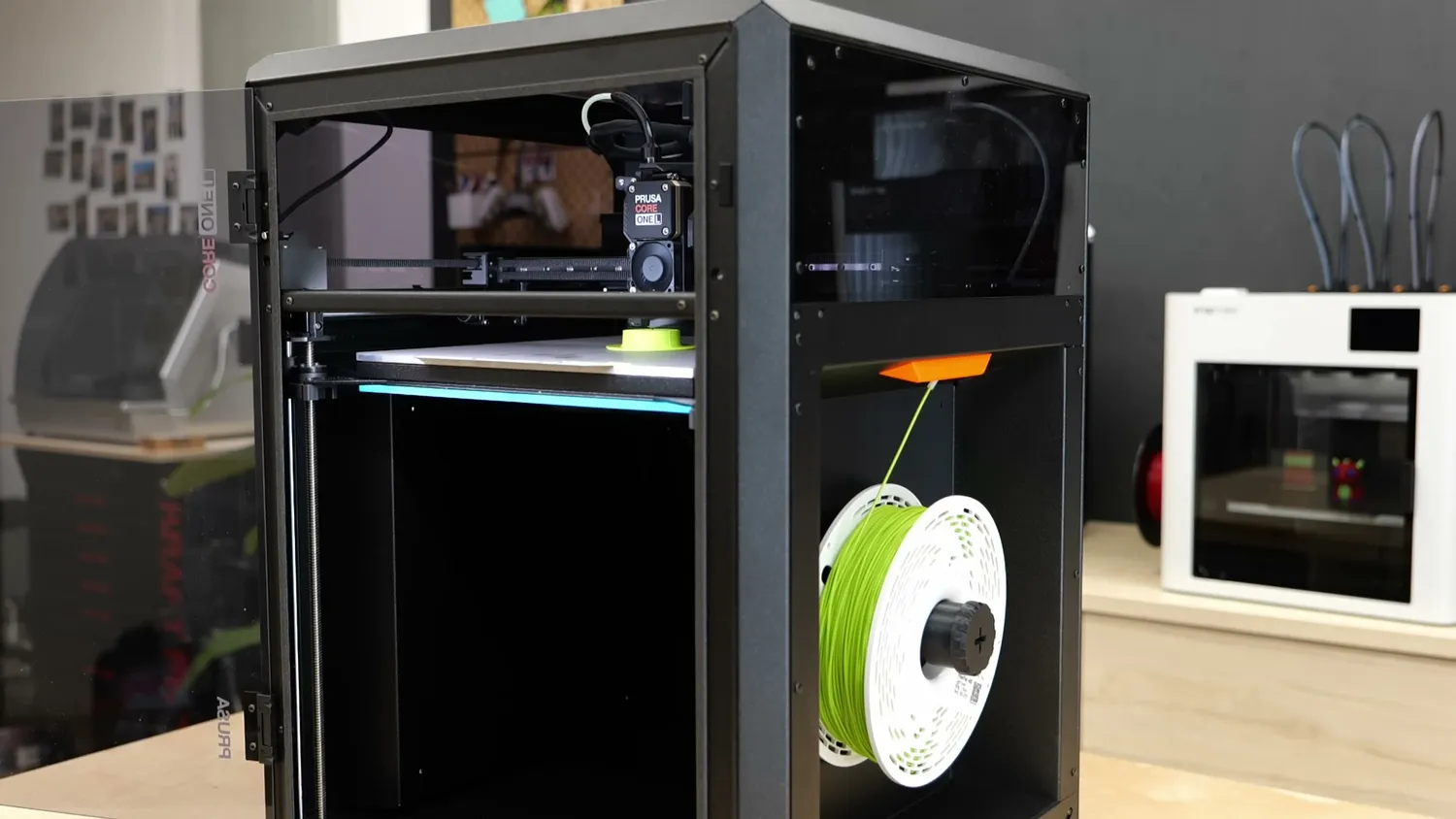 A green TPU spool on the external side holder, feeding into the CORE One L