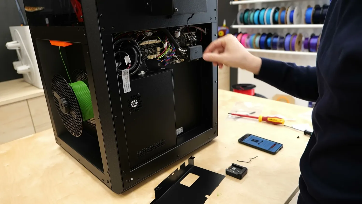 The back panel of the CORE One L removed, exposing the mainboard during the filter installation