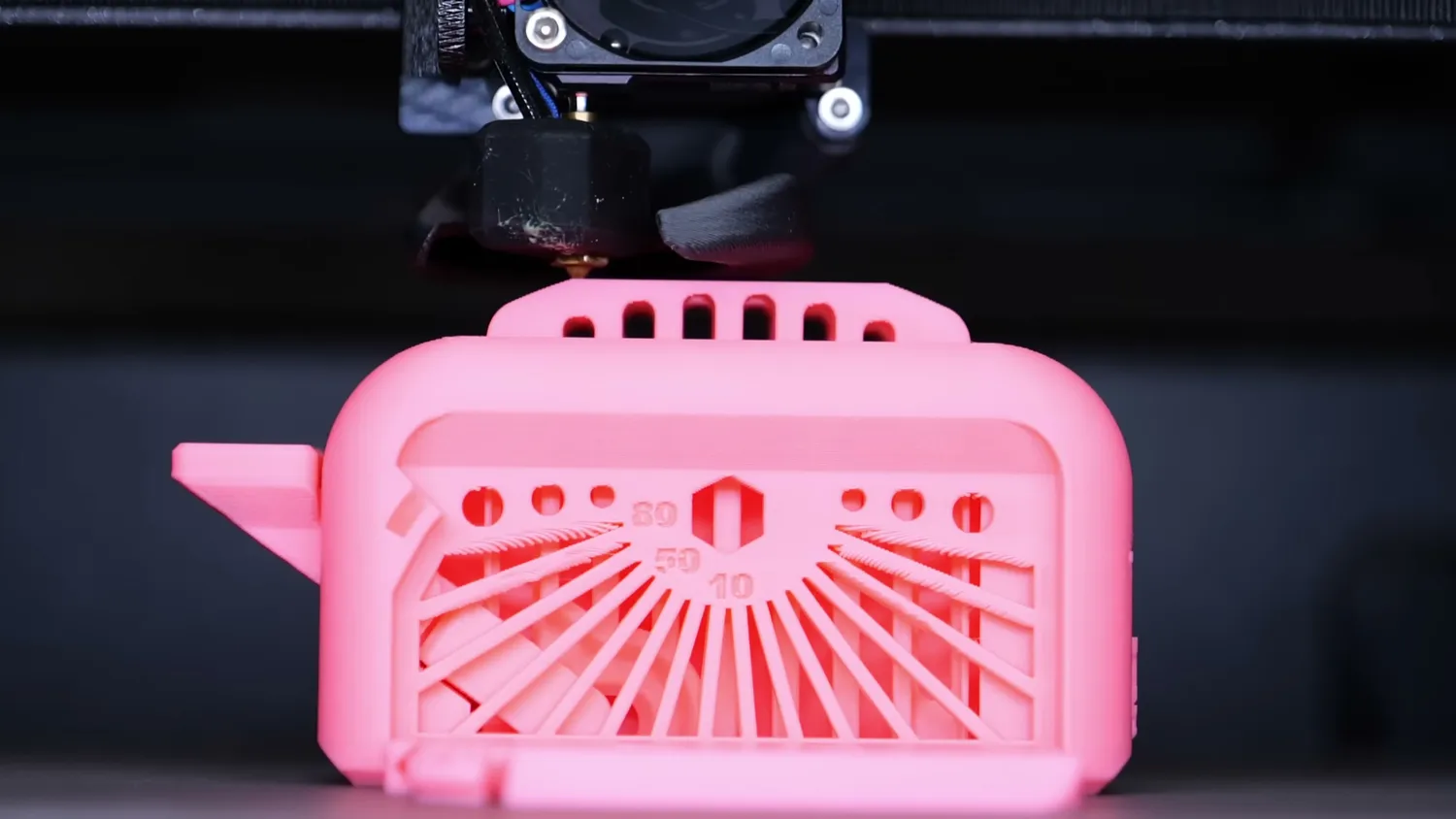 The pink Torture Toaster being printed in PLA inside the enclosed chamber