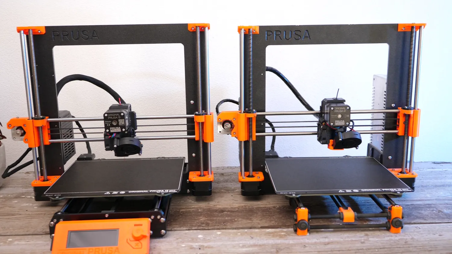 The converted Prusa next to a stock MK3, identical apart from the missing LCD on the Duet machine