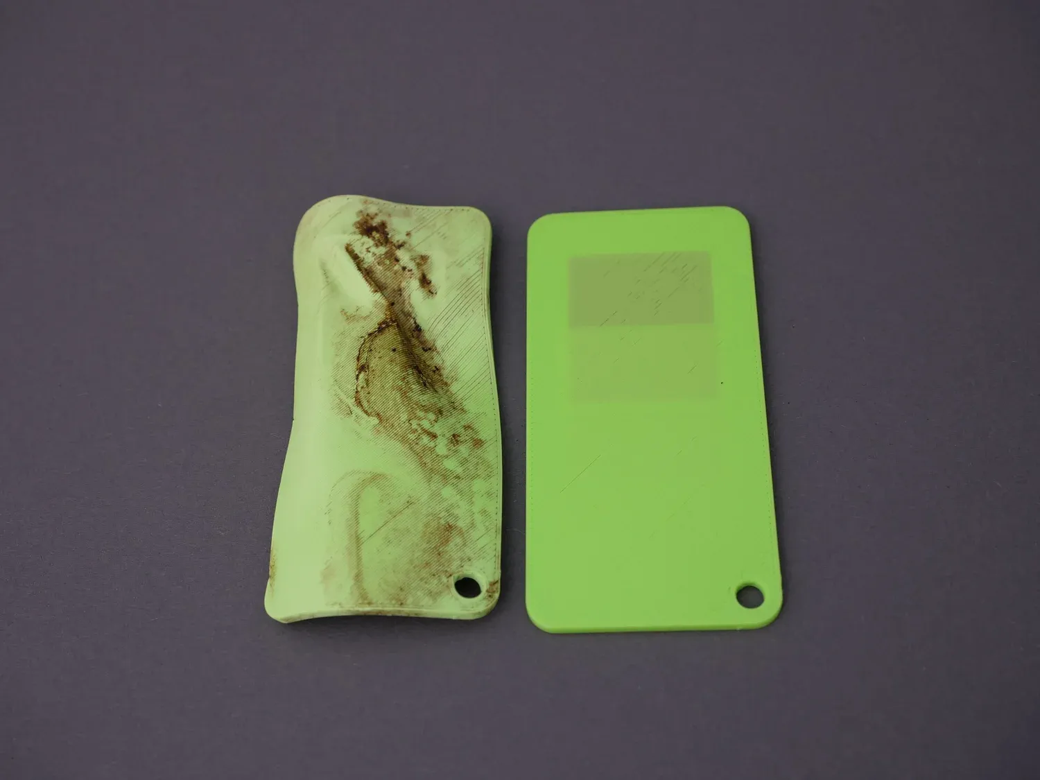 The green degradation card next to an untouched reference, warped and discoloured but with every membrane still present