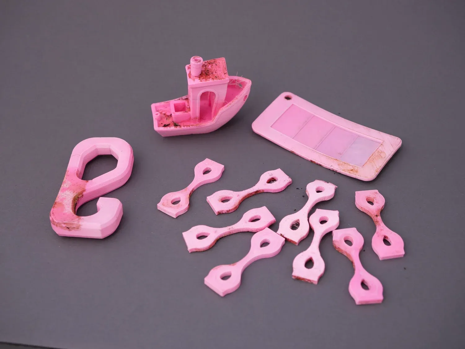The pink PLA/PHA samples, noticeably paler and slightly deformed