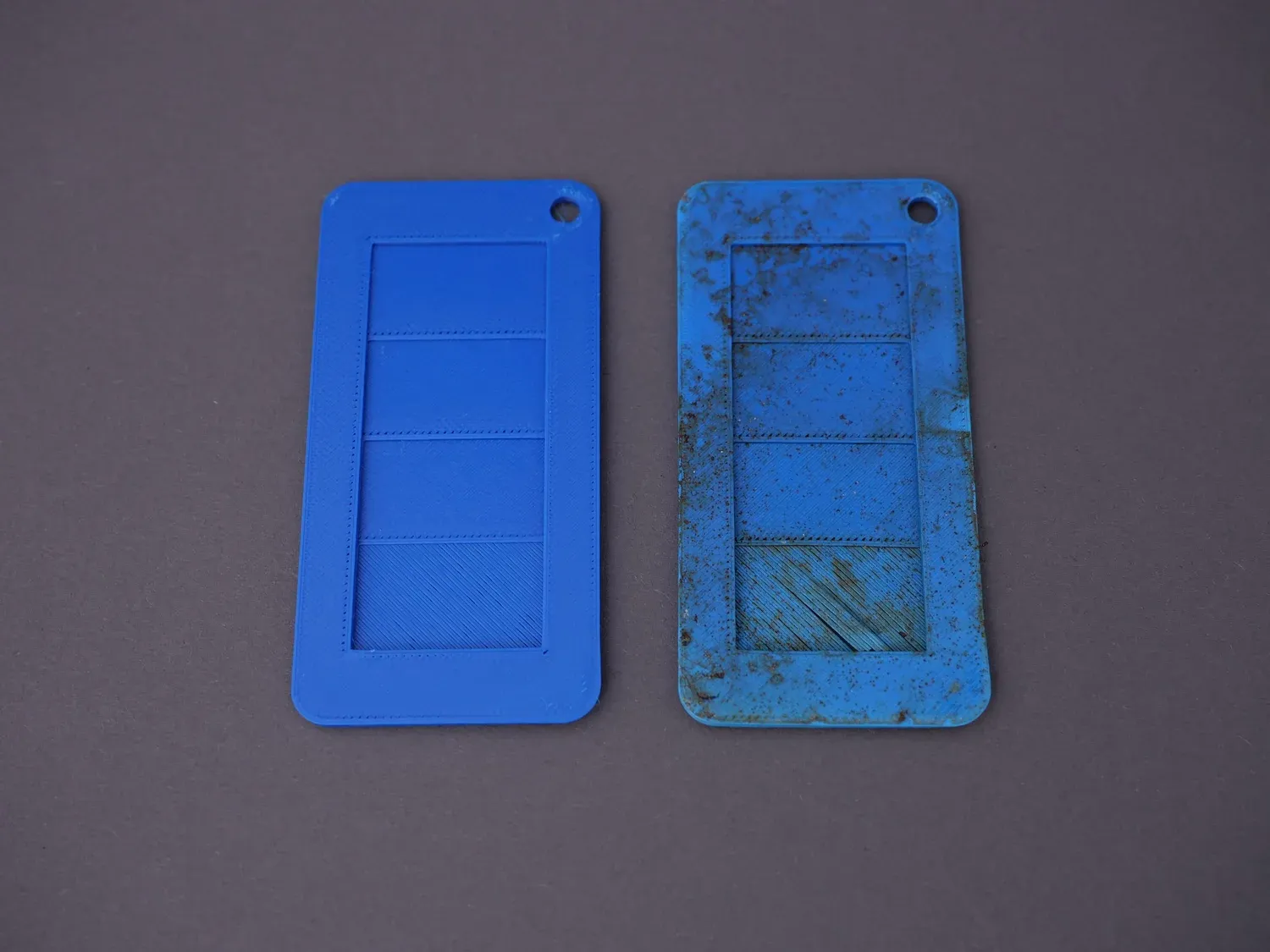 The blue degradation card next to its reference, mottled with soil but otherwise unchanged