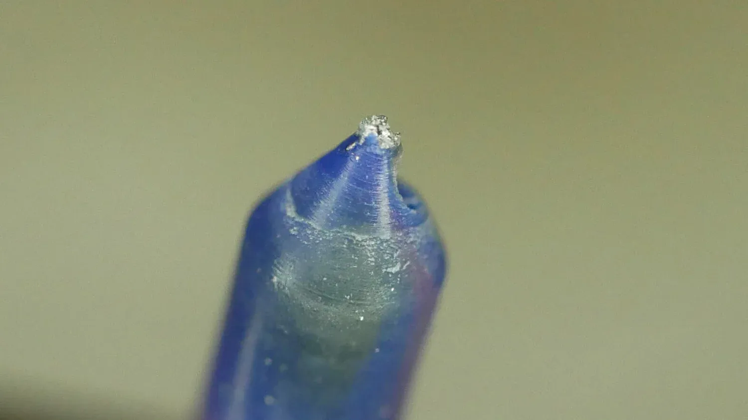 The same problem in blue filament, a silvery fleck embedded right at the tip