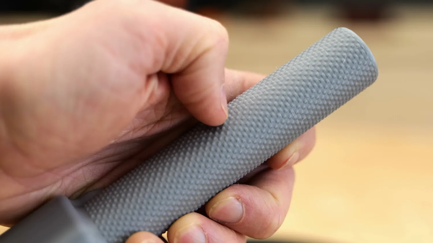 Hand gripping the textured section of a 3D printed microphone handle