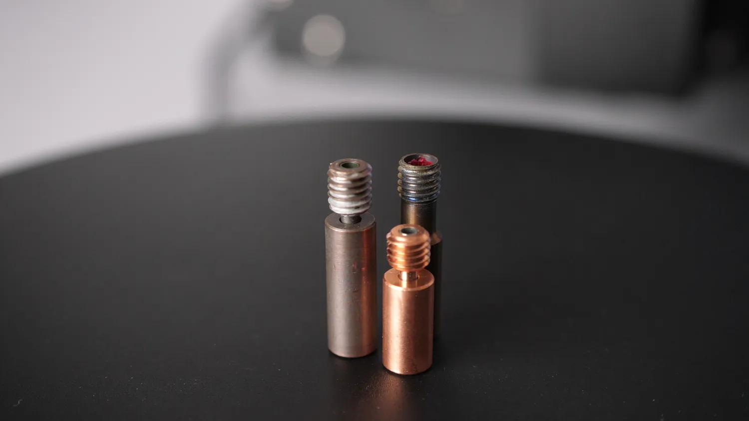  Copperhead Heat Break (left), BiMetal Heatbreak from eBay (front) and Bowden Heatbreak Tube (right) 