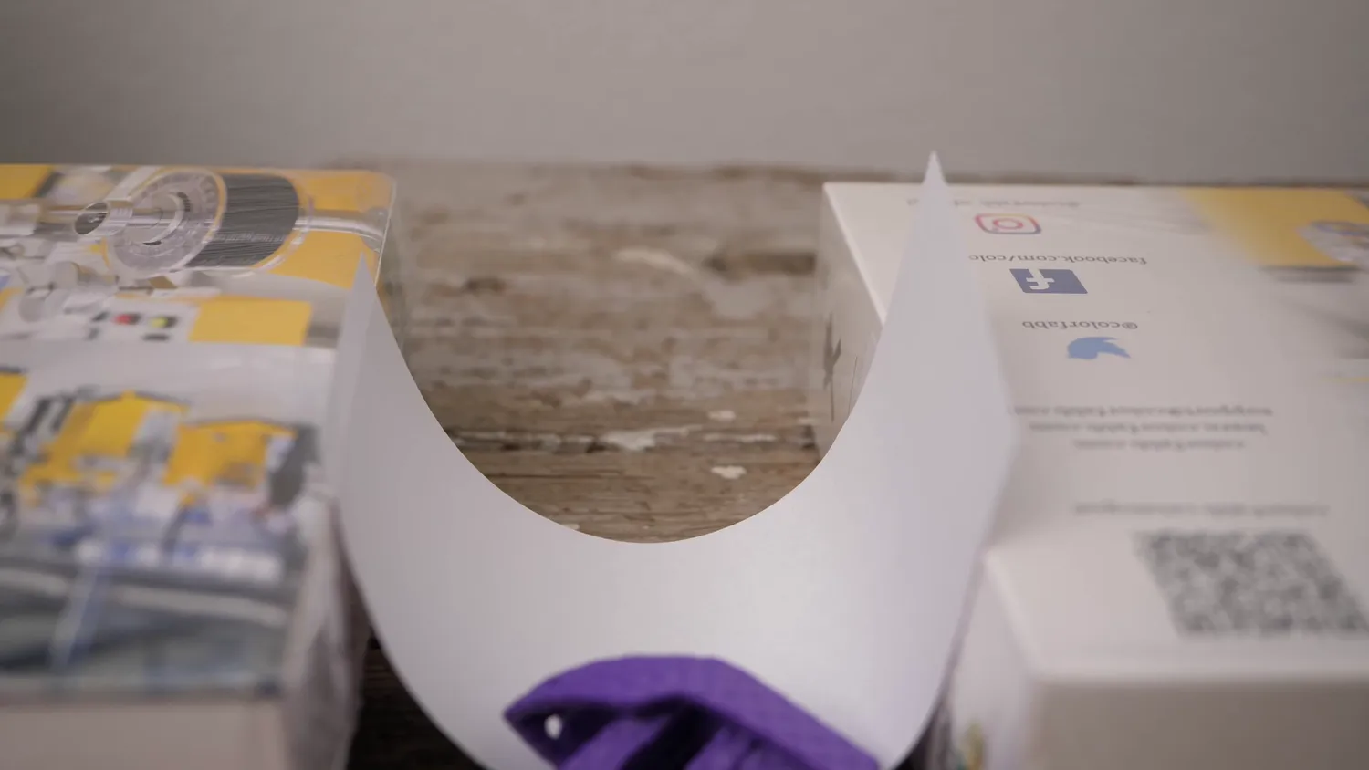 A flat sheet of paper bridging two boxes, sagging under its own weight