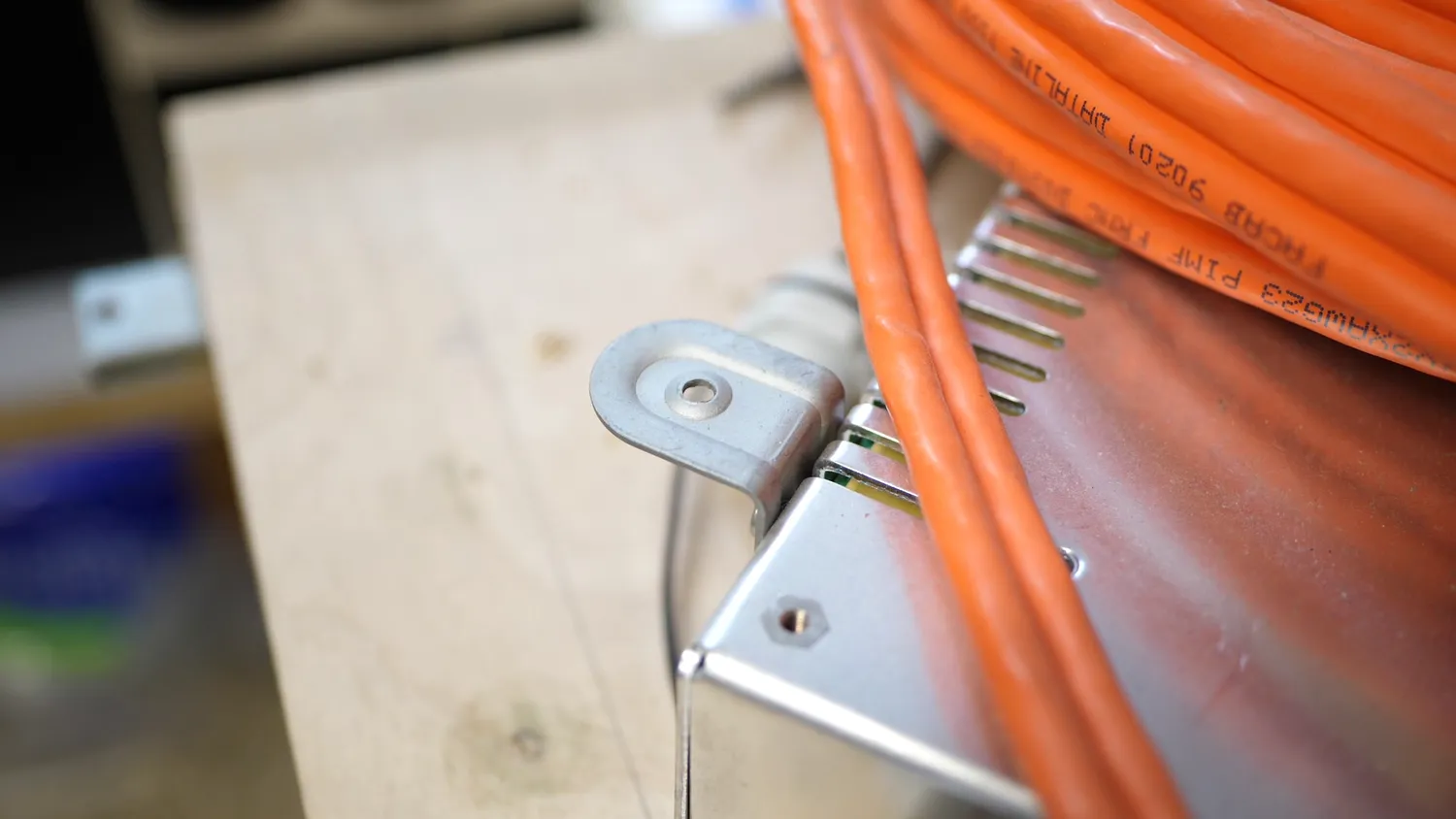Stamped bead in a sheet metal bracket on a cable drum