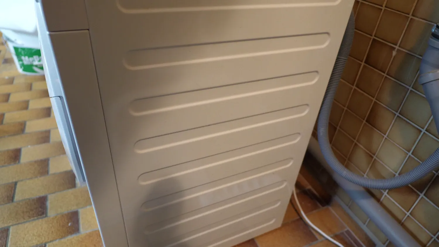 Rolled beads across the side panel of a washing machine