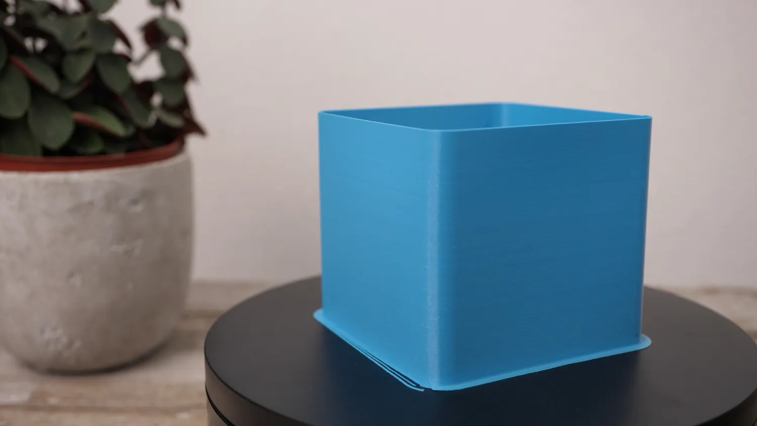Vase-mode cube printed smooth in blue PLA, which barely warps