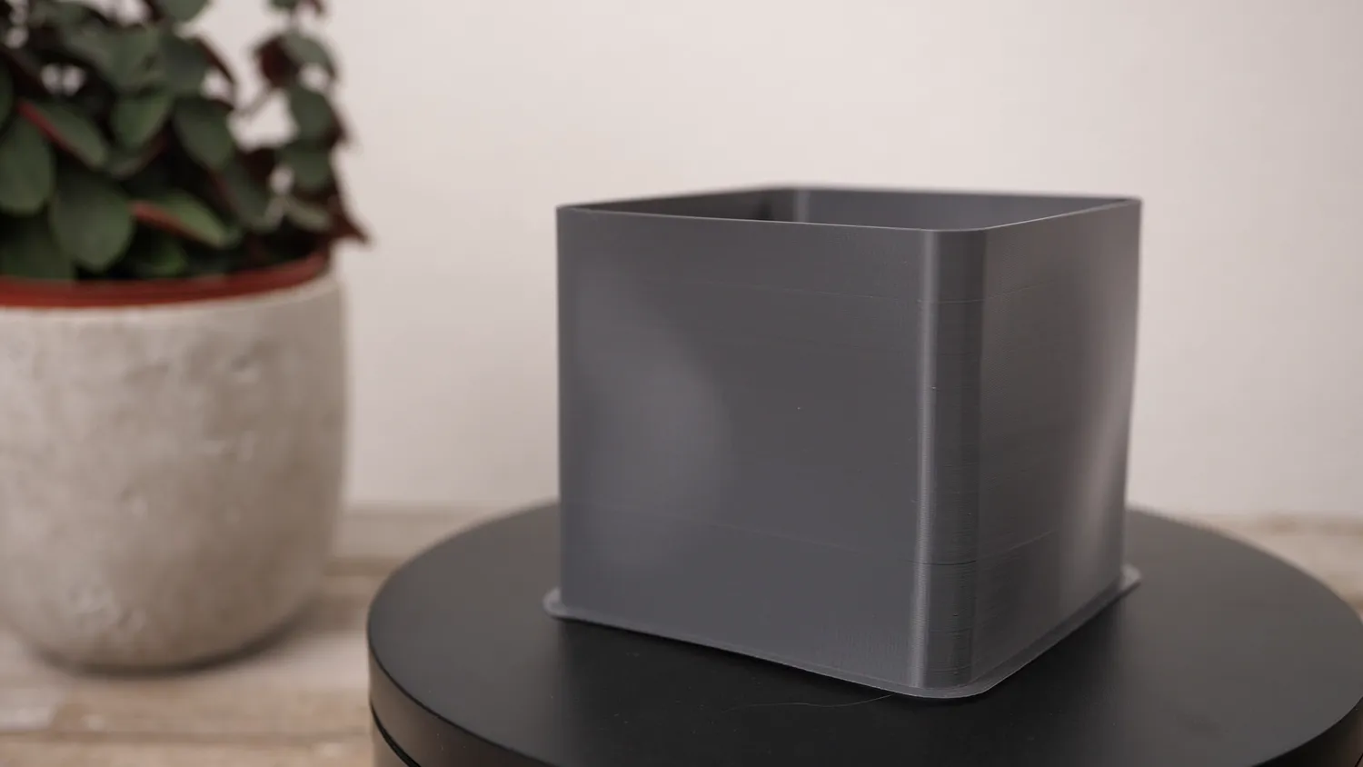 The same cube in PETG, its flat sides already pulled slightly inwards