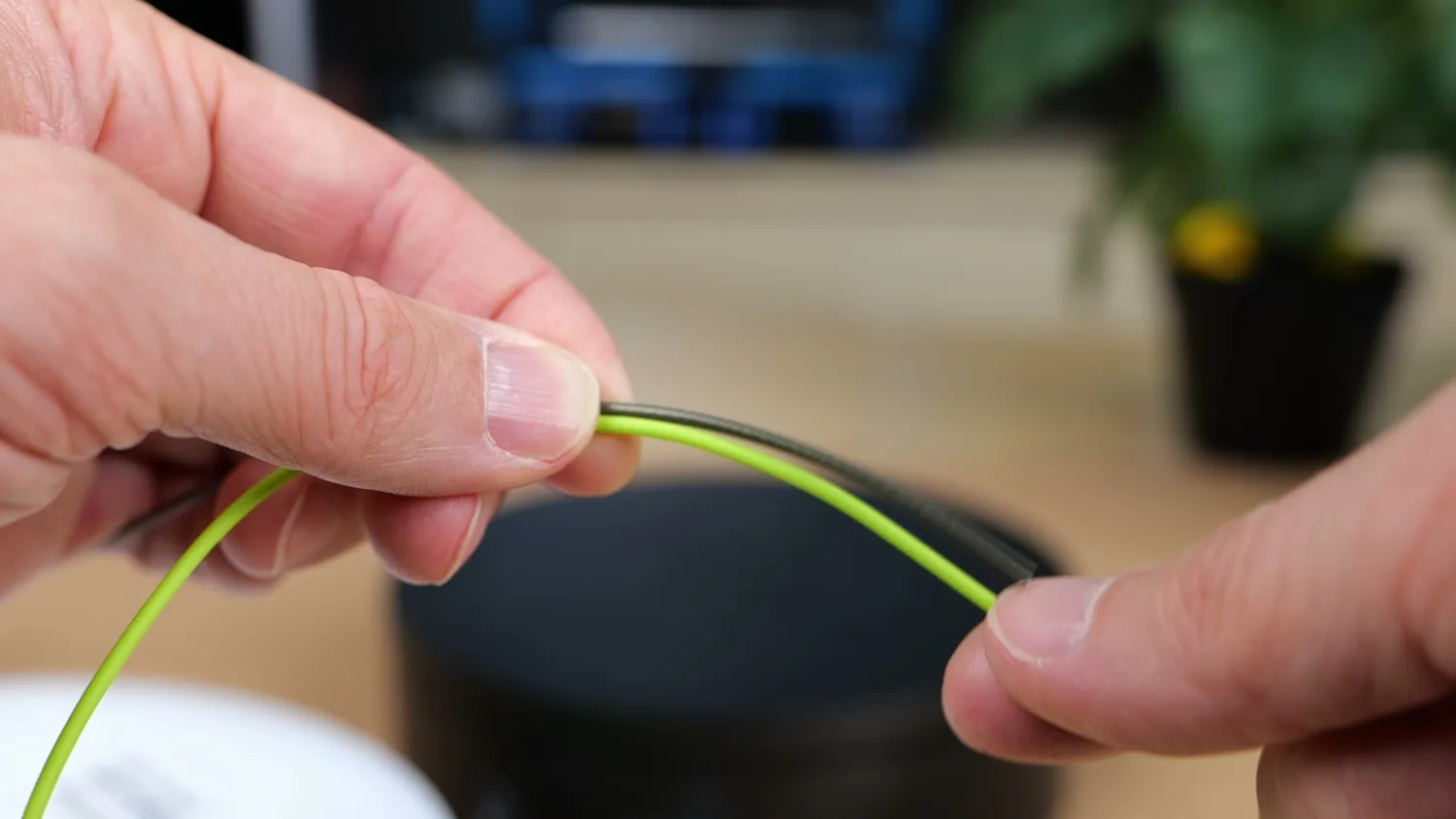 Two filament strands bent between fingers