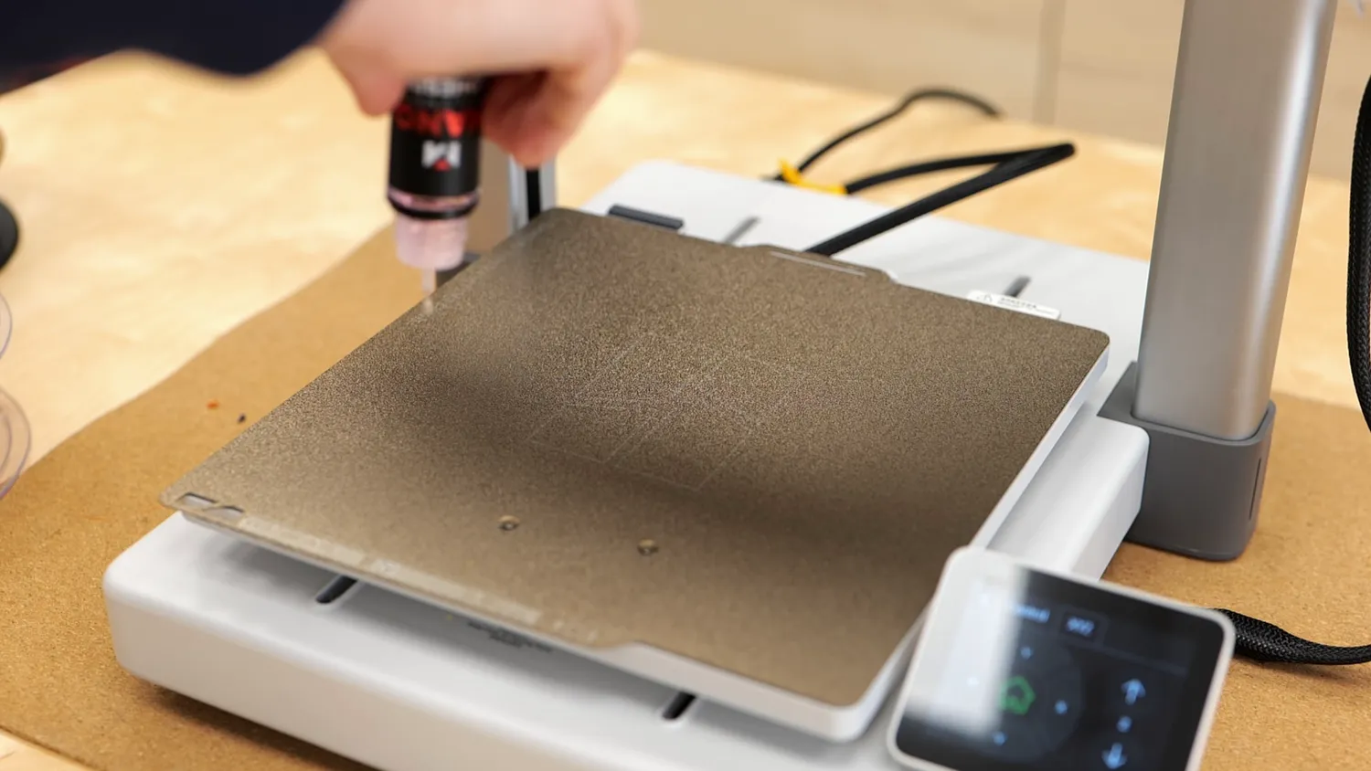 Applying adhesive to a powder-coated PEI build plate