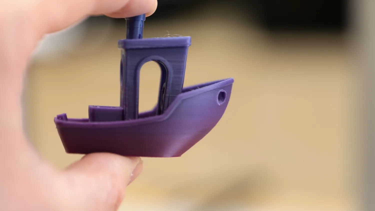 3D printed Benchy held in hand showing smooth side walls