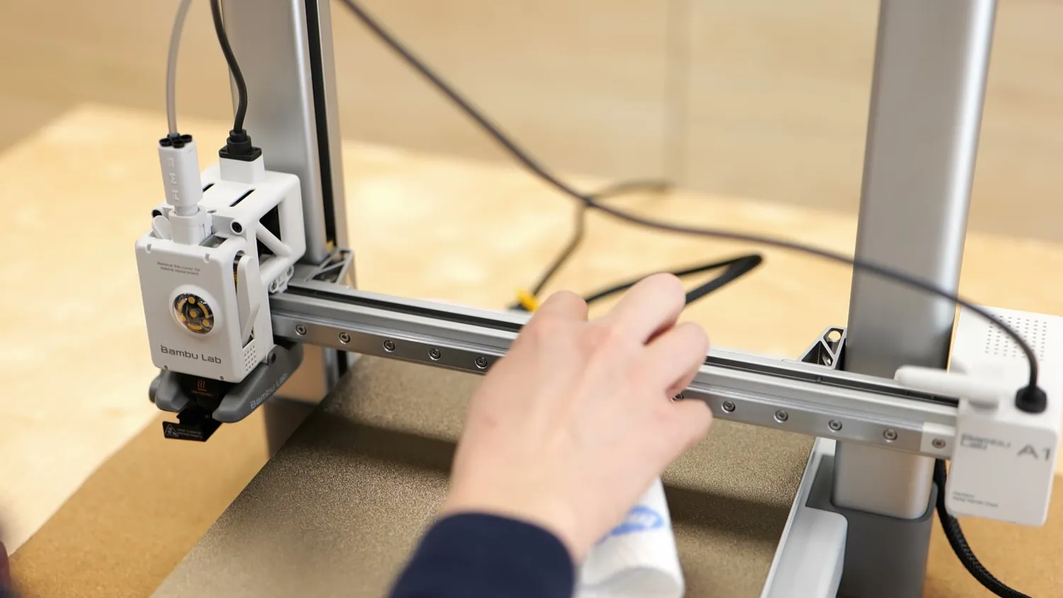 Wiping down the linear rail of a 3D printer