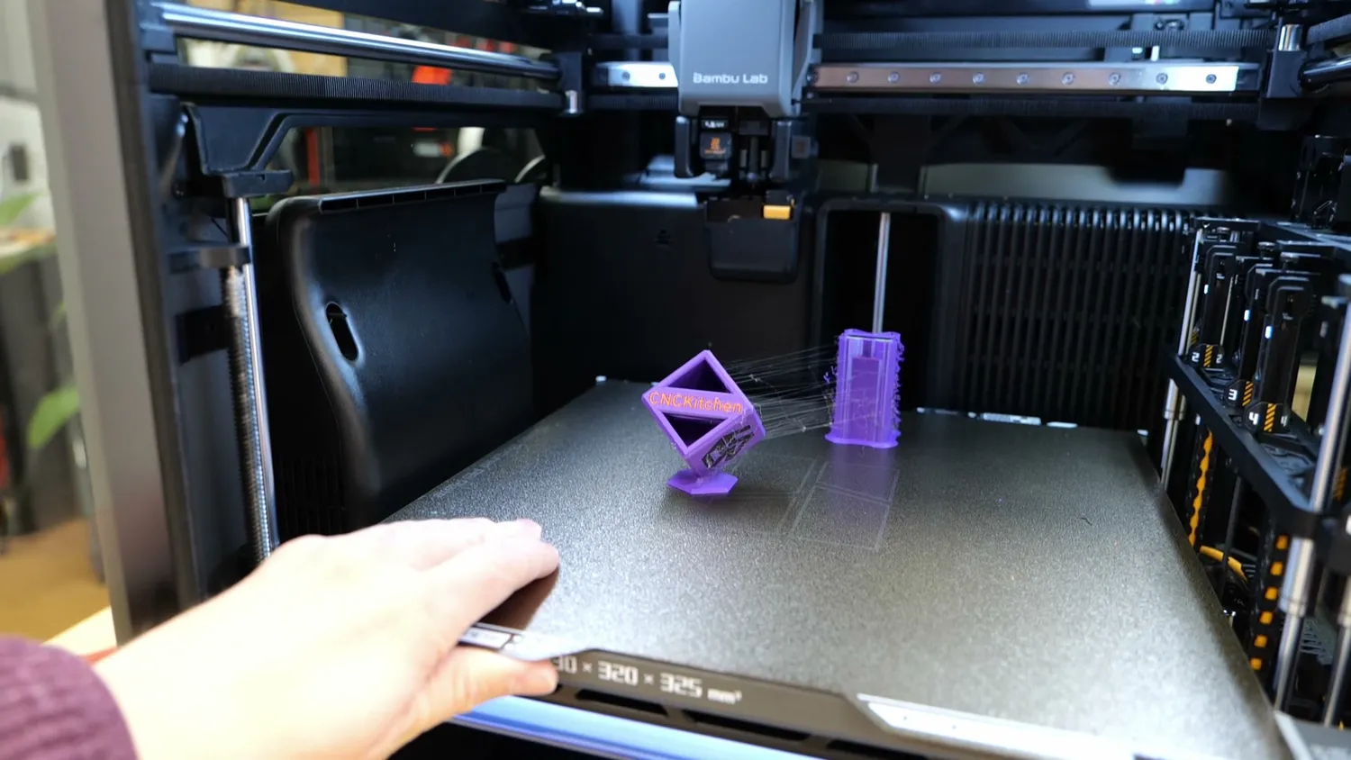 Multi-color print next to its purge tower on the H2C build plate