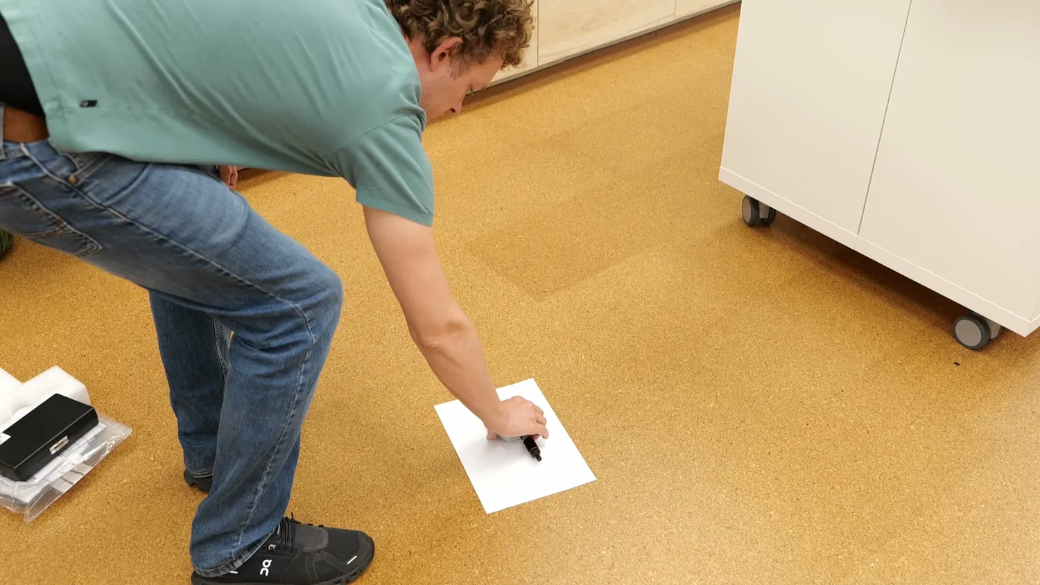 Placing an A4 sheet on the floor to photograph tools