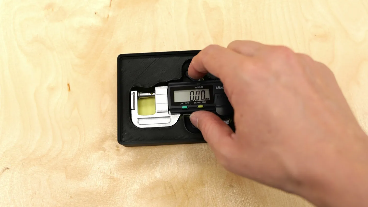 Micrometer in a printed bin with a finger notch