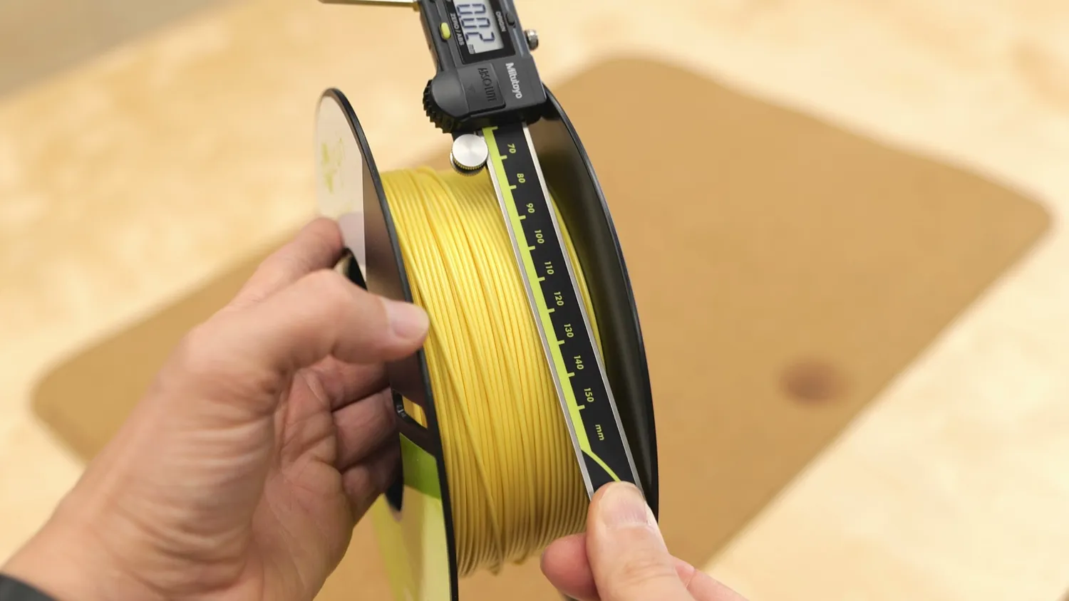 Pale yellow PLA filament measured with a Mitutoyo caliper