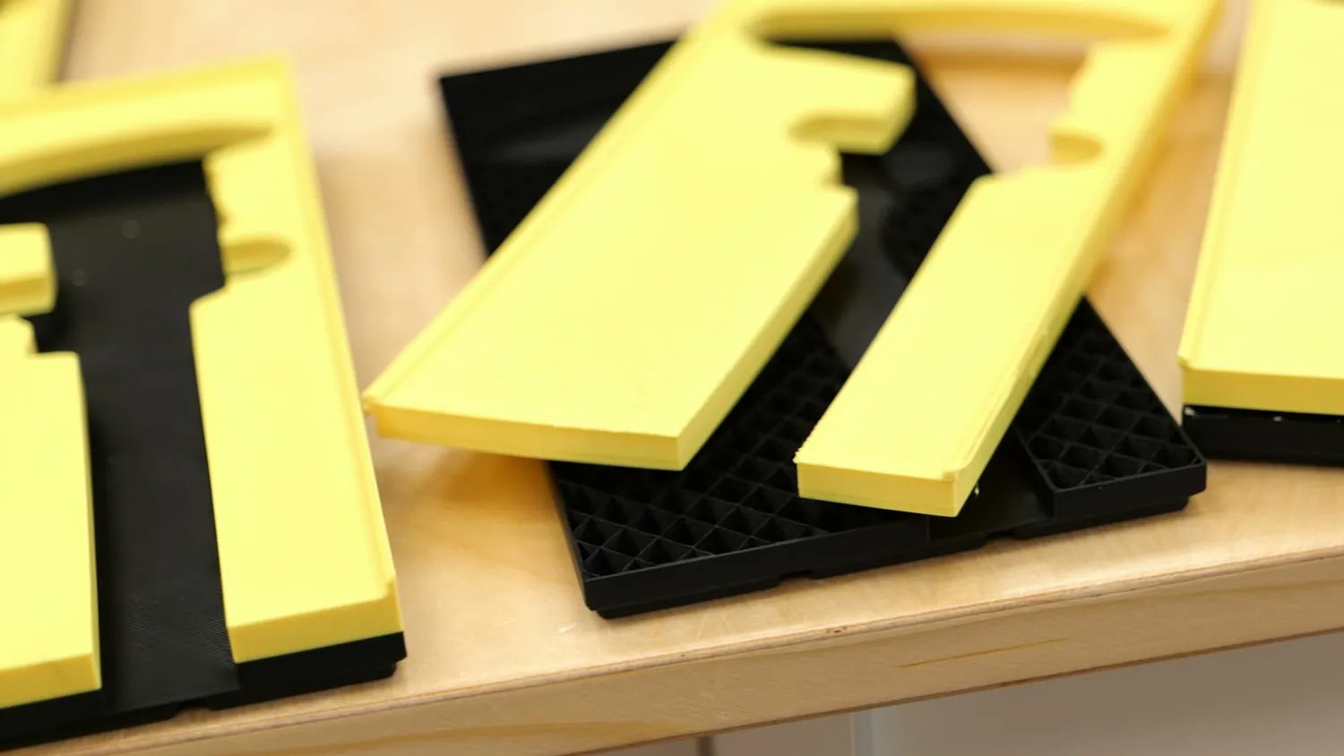 Yellow bin tops separated from their black bases after the layers split