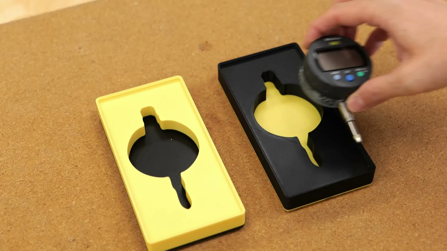 Yellow bin with black insert next to a black bin with yellow insert