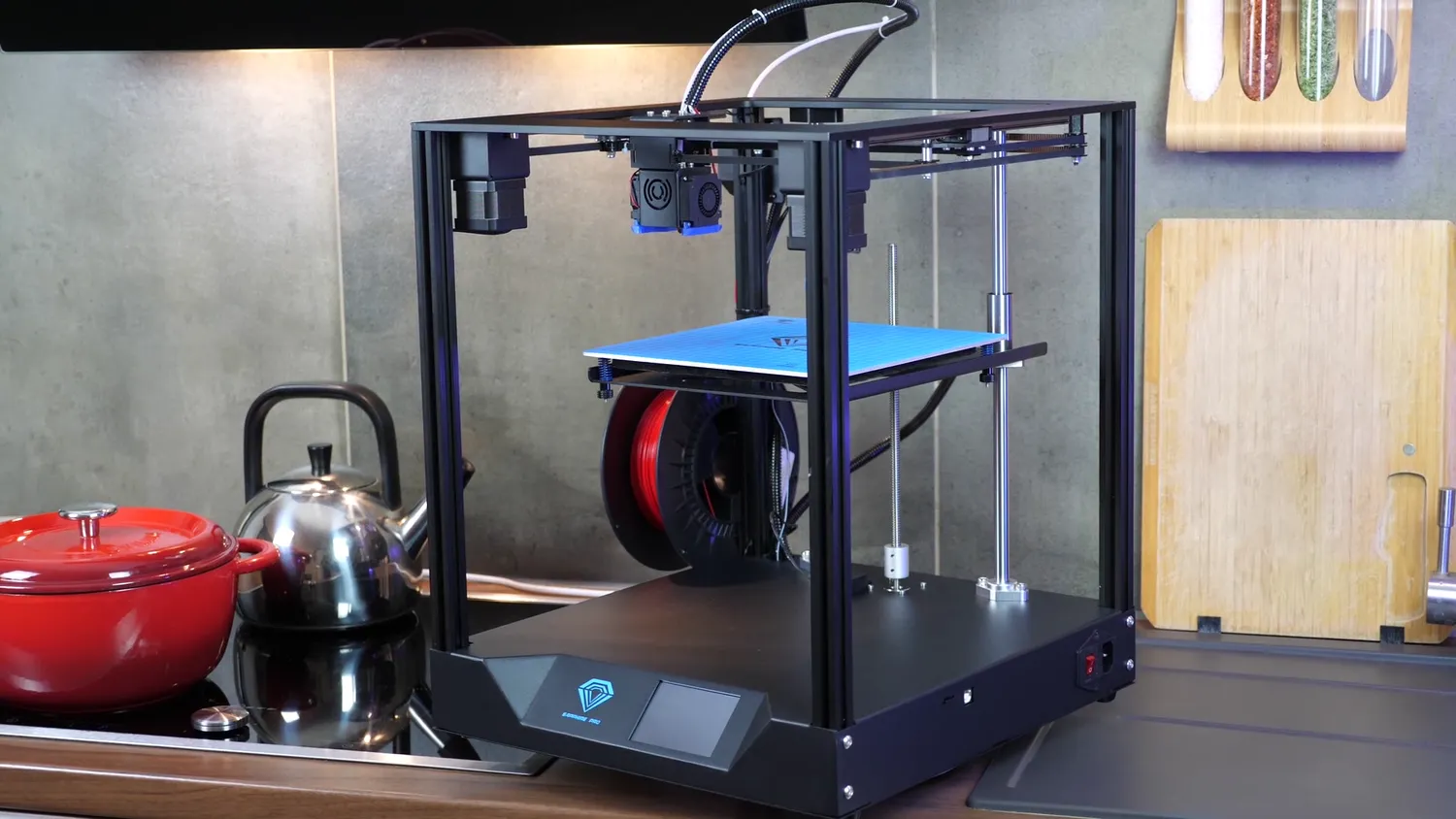 The assembled Two Trees Sapphire Pro, a black coreXY cube with the spool mounted under the blue bed and a touchscreen in the base