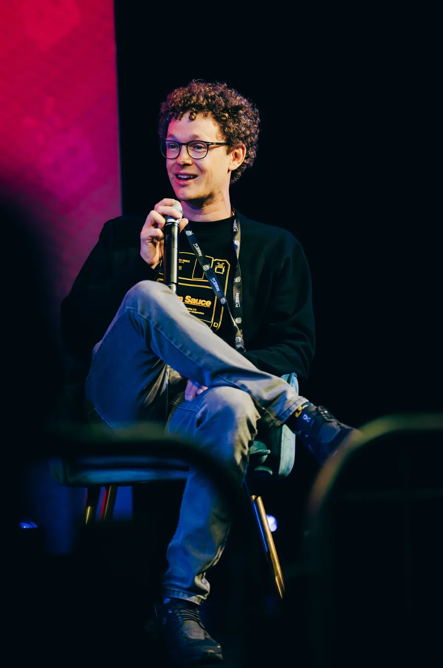 Stefan Hermann speaking with a microphone during a panel talk at Open Sauce
